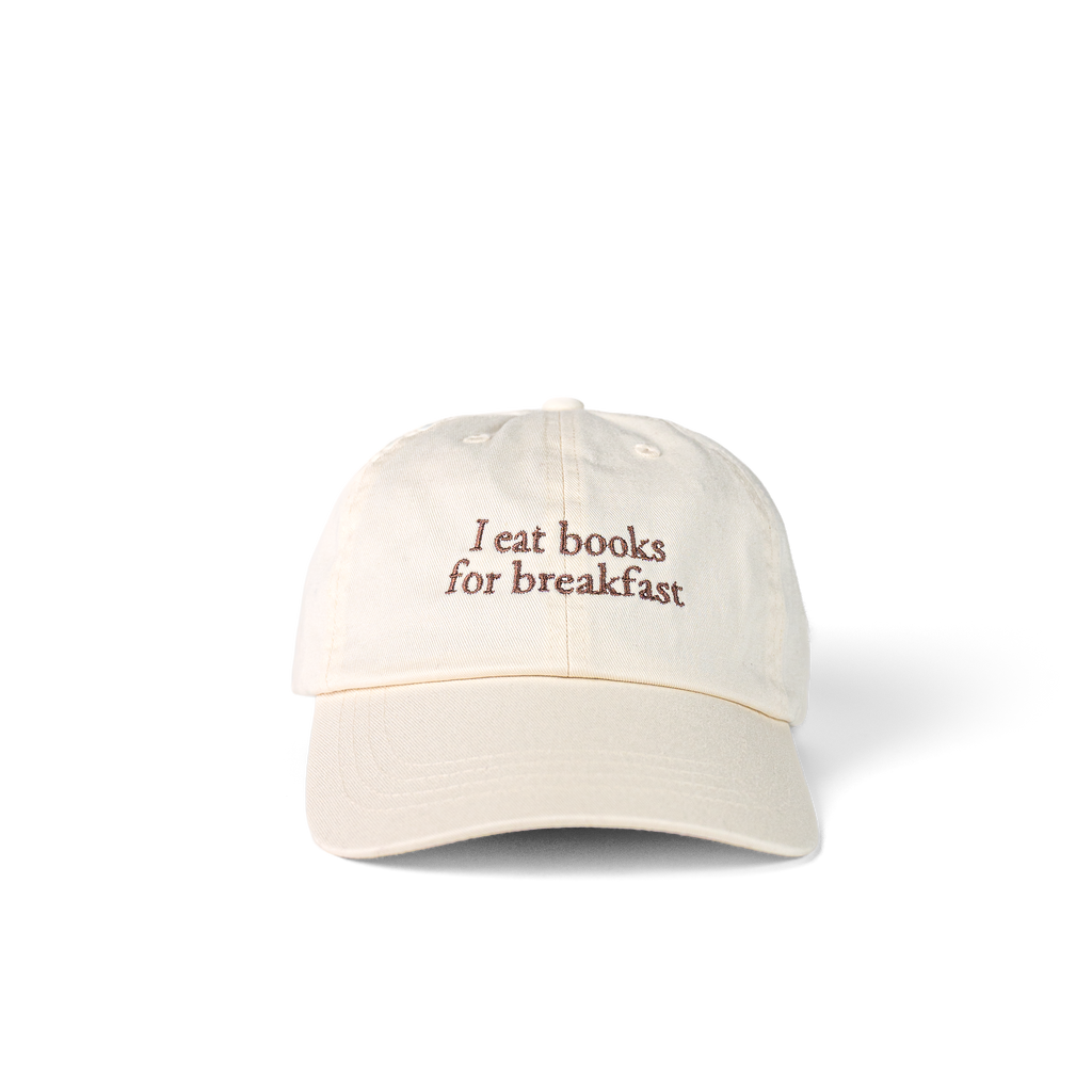 Ada Cap in beige with 'I eat books for breakfast' embroidered on the front