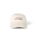 Ada Cap in beige with 'I eat books for breakfast' embroidered on the front