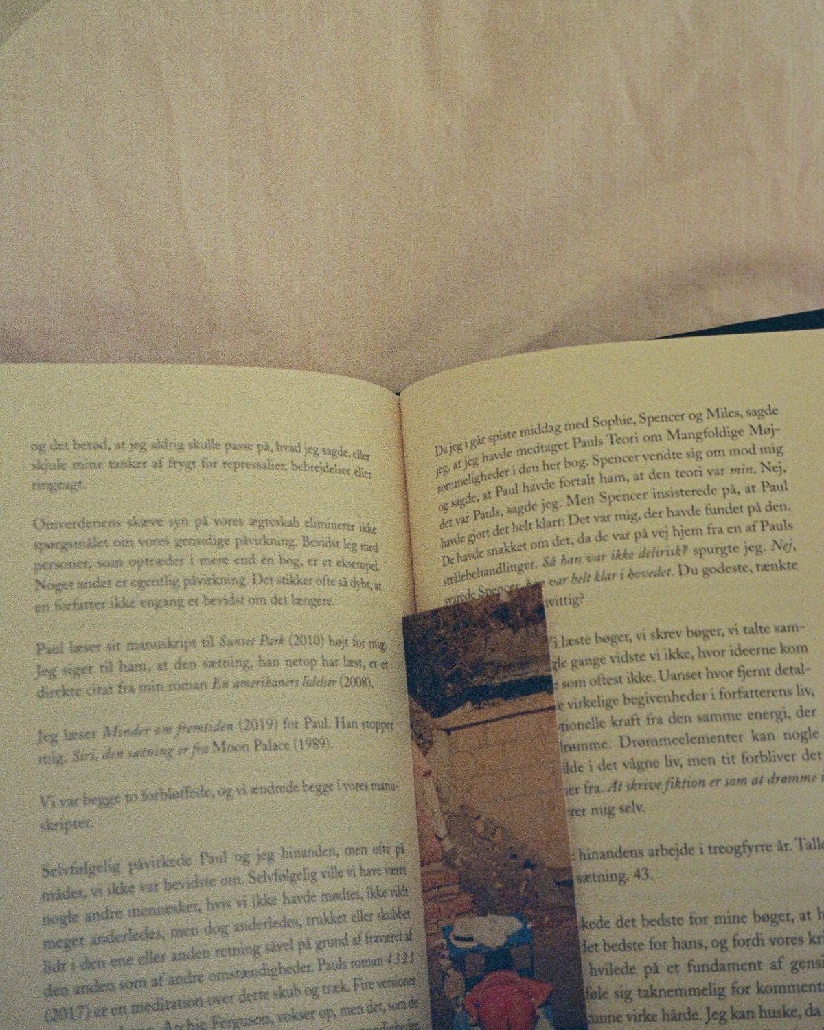 An open book with a photograph used as a bookmark